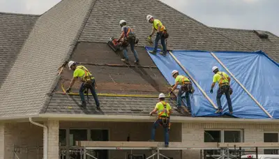 Victorville, CA storm damage restoration crew removing water from a flooded home interior